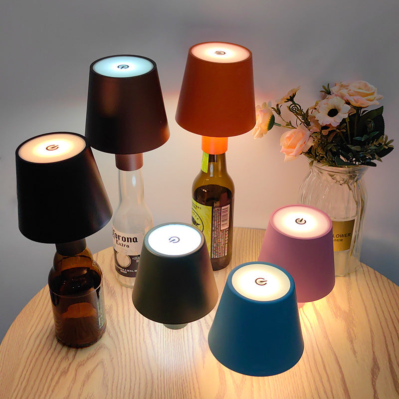 Rechargeable bottle lamp caps in multiple colors on wine bottles restaurant table